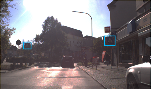 Poorly visible pedestrian crossing as well as poorly visible signage due to sunlight.
